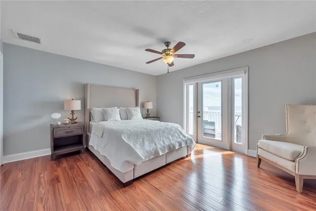 a bedroom with a large bed and a chandelier