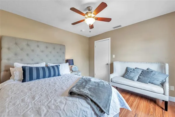 a bedroom with a bed and ceiling fan