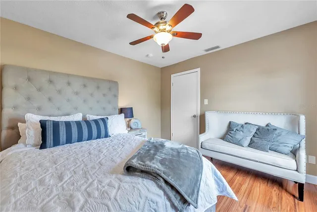a bedroom with a bed and ceiling fan