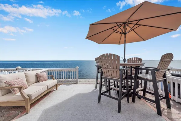 a view of an outdoor sitting area with furniture and umbrella
