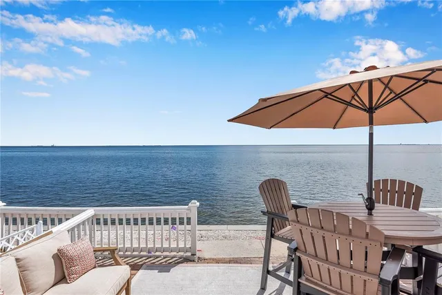 a view of a roof deck with furniture