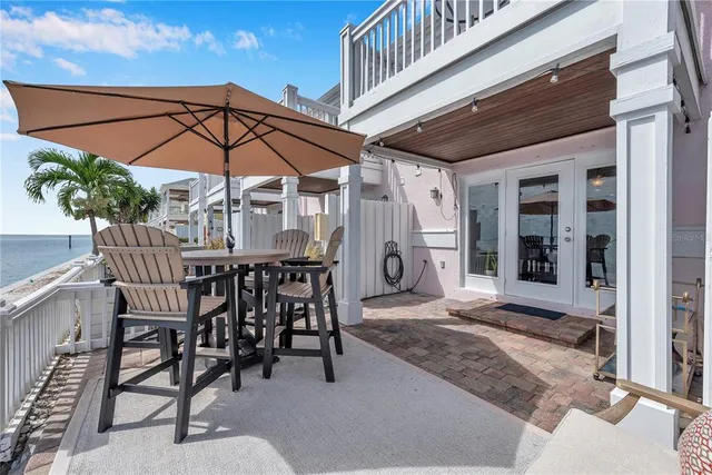 a patio with a table and chairs under an umbrella