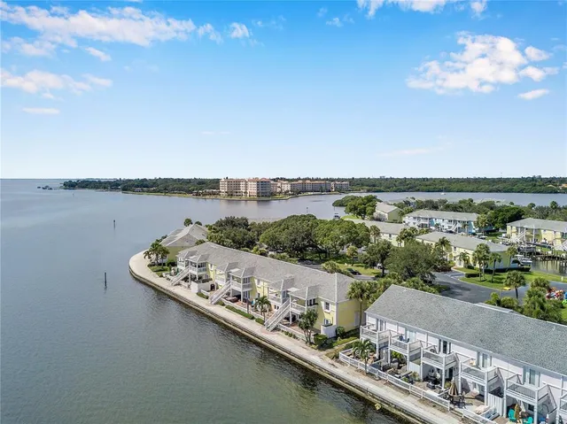 a view of a lake with table and chairs