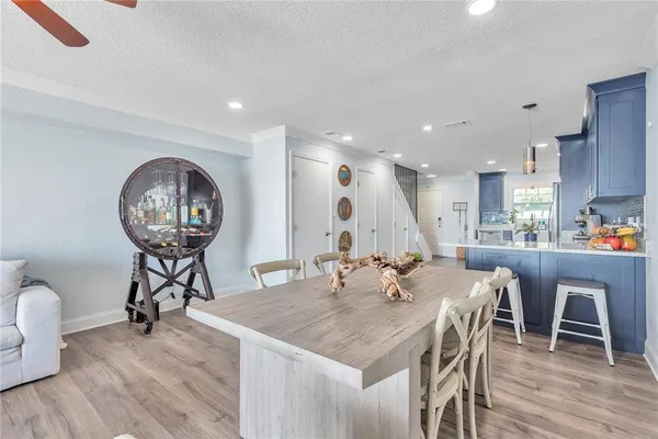 a view of a dining room with furniture wooden floor and a chandelier