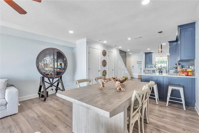 a view of a dining room with furniture wooden floor and a chandelier