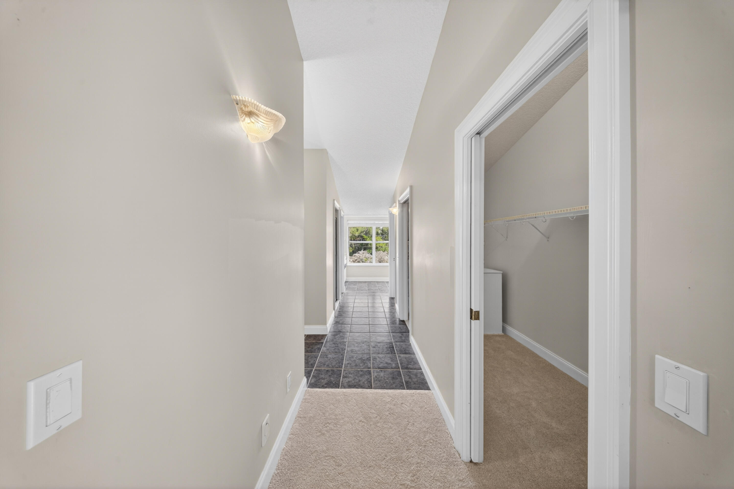 8686 Andrews Avenue Fort Pierce, FL 34945 - Photo 51 of 76 a view of a hallway with wooden floor and a bathroom