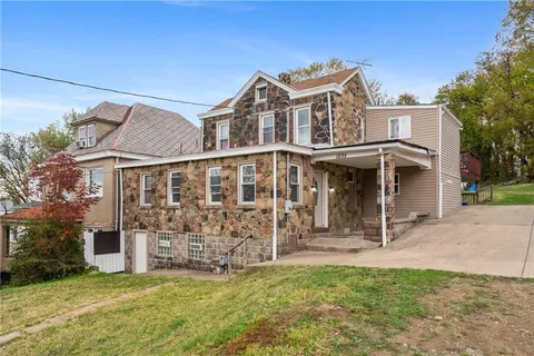 a view of a house with a yard and sitting area