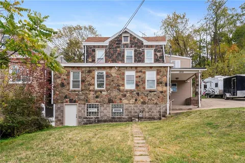 front view of a house with a yard