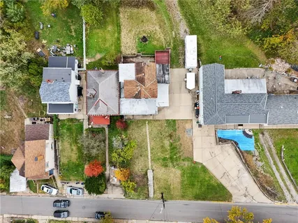 an aerial view of residential houses with outdoor space and street view
