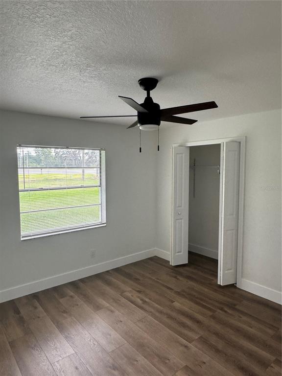 18208 State Road 52 Land O Lakes, FL 34638 - Photo 16 of 44 a view of empty room with wooden floor and fan