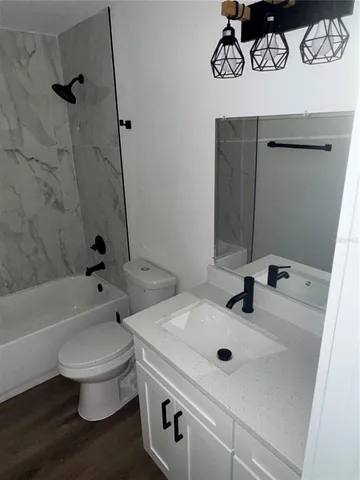 a bathroom with a sink a toilet and a bathtub