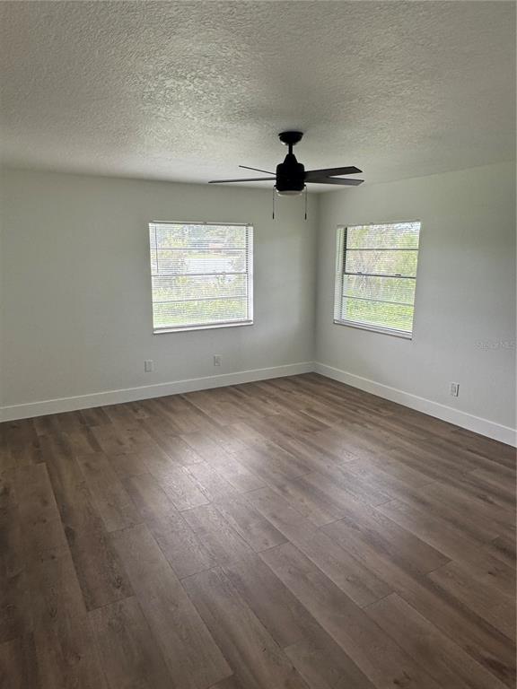 18208 State Road 52 Land O Lakes, FL 34638 - Photo 19 of 44 an empty room with wooden floor and windows