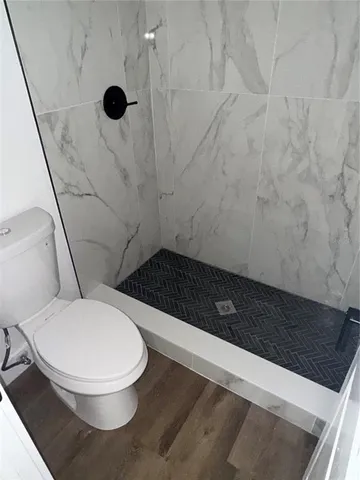 a bathroom with a toilet and a shower