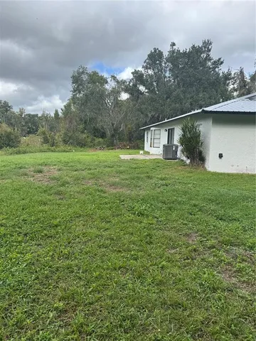 a backyard of a house with lots of green space