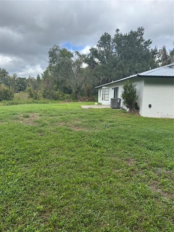 18208 State Road 52 Land O Lakes, FL 34638 - Photo 28 of 44 a backyard of a house with lots of green space