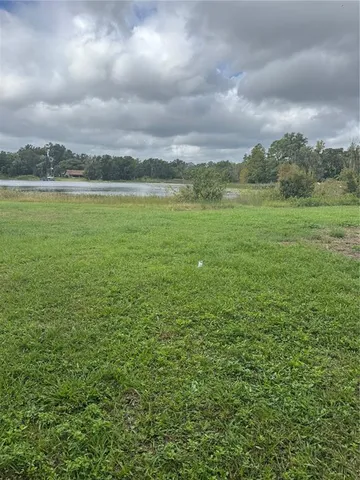 a view of a field with an ocean