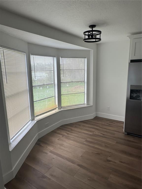 18208 State Road 52 Land O Lakes, FL 34638 - Photo 3 of 44 a view of an empty room with a window and wooden floor
