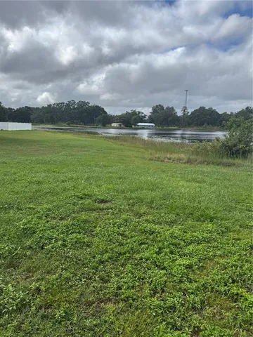 a view of a lake with houses in the back