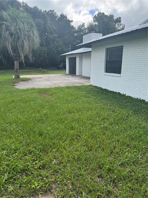 18208 State Road 52 Land O Lakes, FL 34638 - Photo 41 of 44 a backyard of a house with lots of green space