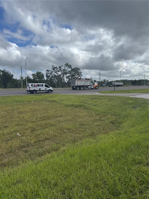 18208 State Road 52 Land O Lakes, FL 34638 - Photo 44 of 44 a view of a big yard of grass and an empty room