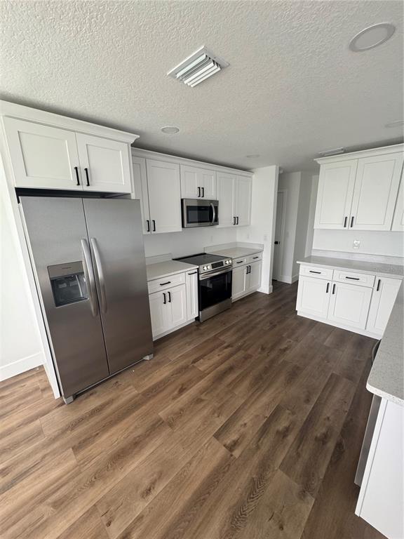 18208 State Road 52 Land O Lakes, FL 34638 - Photo 8 of 44 a kitchen with stainless steel appliances granite countertop a refrigerator a stove top oven a sink and dishwasher