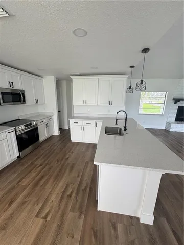 a kitchen with a sink a stove and cabinets