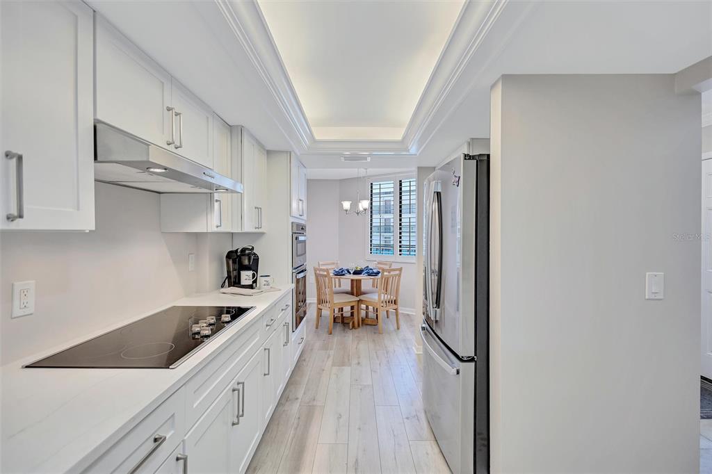 5880 Midnight Pass Road, Unit 306 Sarasota, FL 34242 - Photo 14 of 71 a large white kitchen with stainless steel appliances