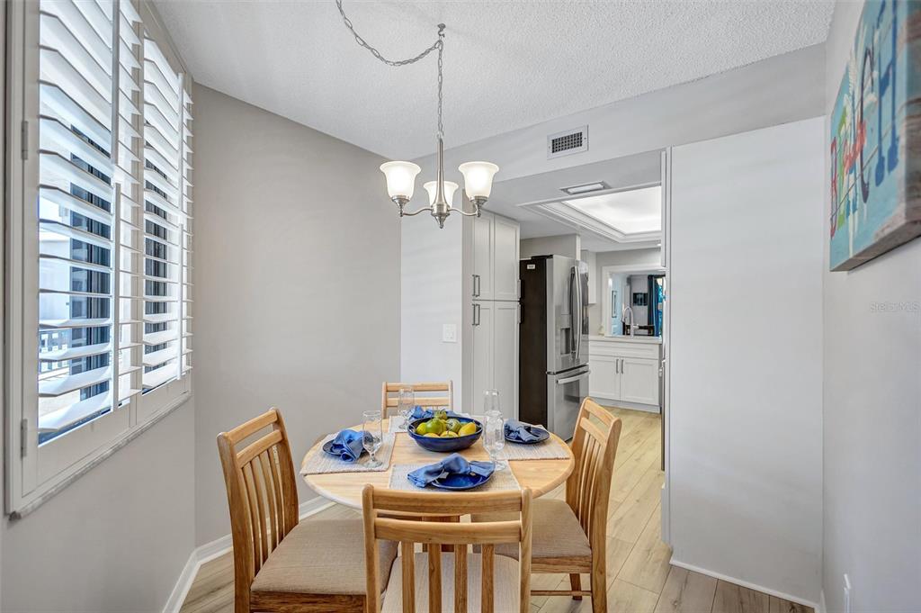 5880 Midnight Pass Road, Unit 306 Sarasota, FL 34242 - Photo 19 of 71 a view of a dining room with furniture and a chandelier