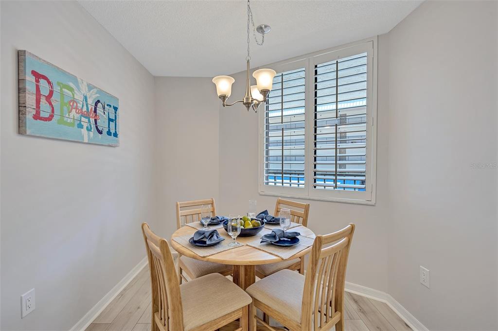 5880 Midnight Pass Road, Unit 306 Sarasota, FL 34242 - Photo 20 of 71 a view of a dining room with furniture window and chandelier