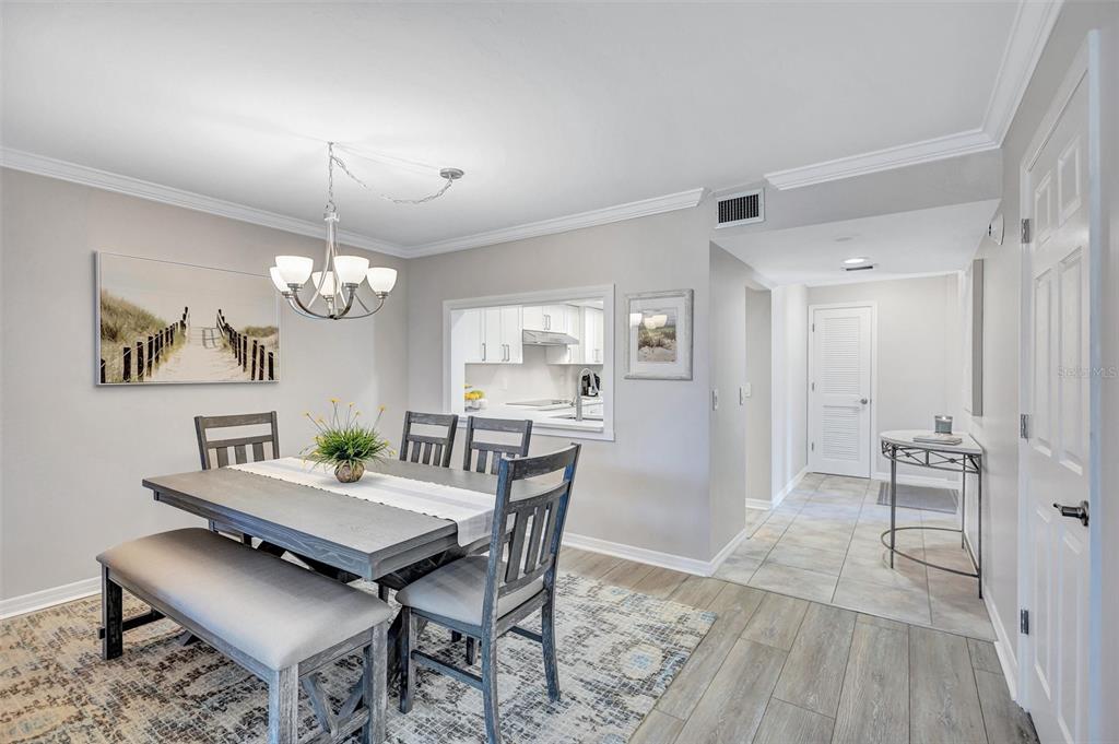 5880 Midnight Pass Road, Unit 306 Sarasota, FL 34242 - Photo 21 of 71 a view of a dining room with furniture window and wooden floor