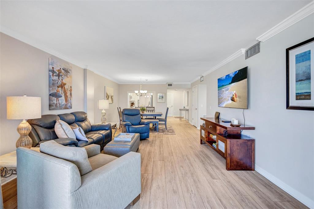 5880 Midnight Pass Road, Unit 306 Sarasota, FL 34242 - Photo 27 of 71 a living room with furniture and wooden floor