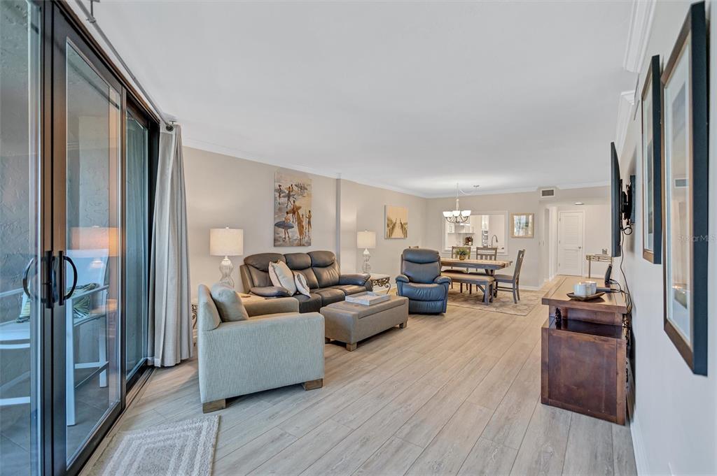 5880 Midnight Pass Road, Unit 306 Sarasota, FL 34242 - Photo 28 of 71 a living room with furniture and a wooden floor