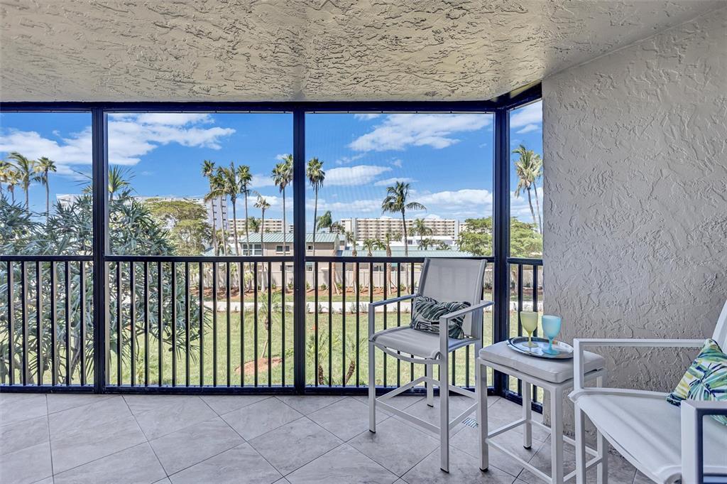 5880 Midnight Pass Road, Unit 306 Sarasota, FL 34242 - Photo 29 of 71 a view of a chair and table in the balcony