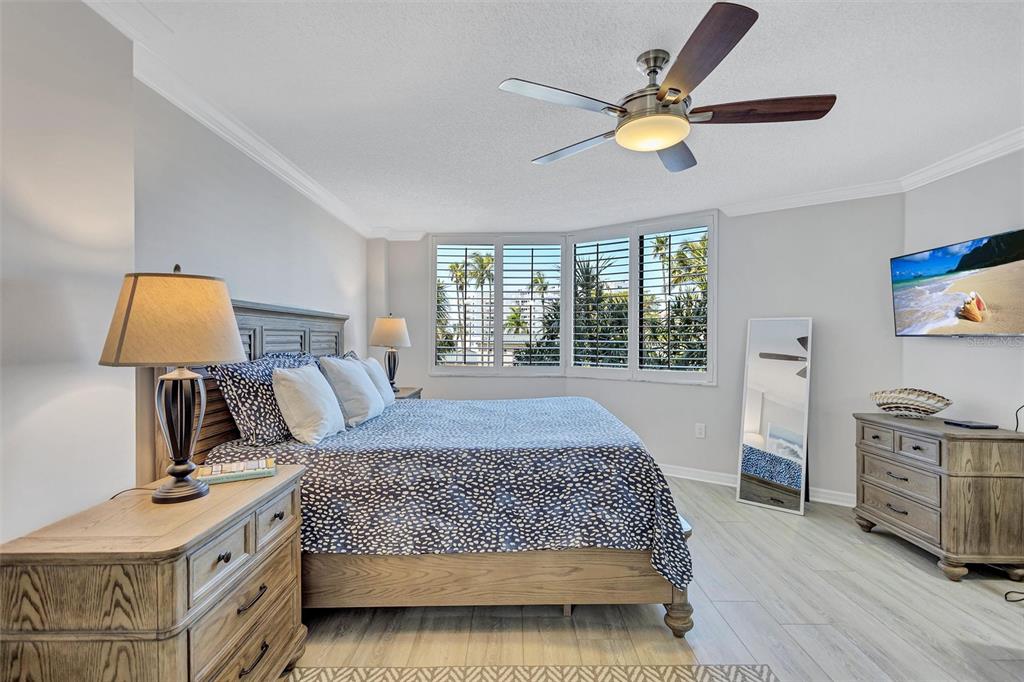5880 Midnight Pass Road, Unit 306 Sarasota, FL 34242 - Photo 34 of 71 a bedroom with a large bed and a window