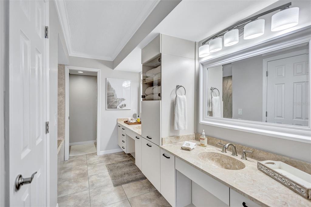 5880 Midnight Pass Road, Unit 306 Sarasota, FL 34242 - Photo 36 of 71 a spacious bathroom with a double vanity sink and a mirror