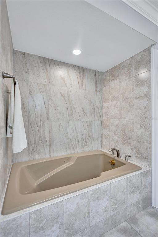 5880 Midnight Pass Road, Unit 306 Sarasota, FL 34242 - Photo 37 of 71 a bathroom with a bathtub and a shower