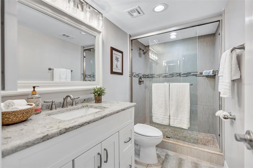 5880 Midnight Pass Road, Unit 306 Sarasota, FL 34242 - Photo 41 of 71 a bathroom with a granite countertop sink toilet and shower