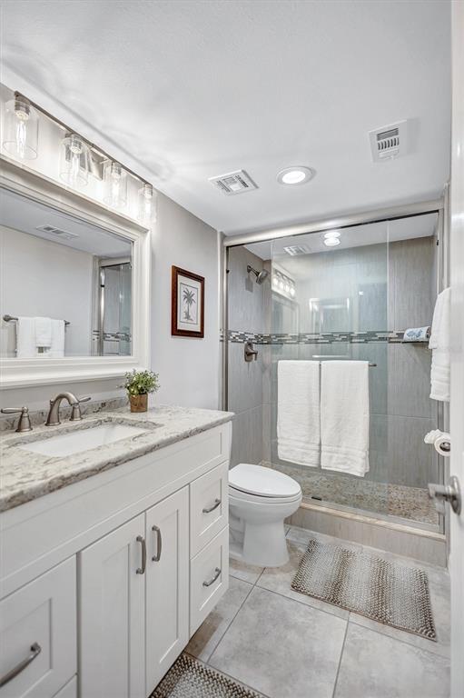 5880 Midnight Pass Road, Unit 306 Sarasota, FL 34242 - Photo 42 of 71 a bathroom with a granite countertop sink mirror vanity and toilet