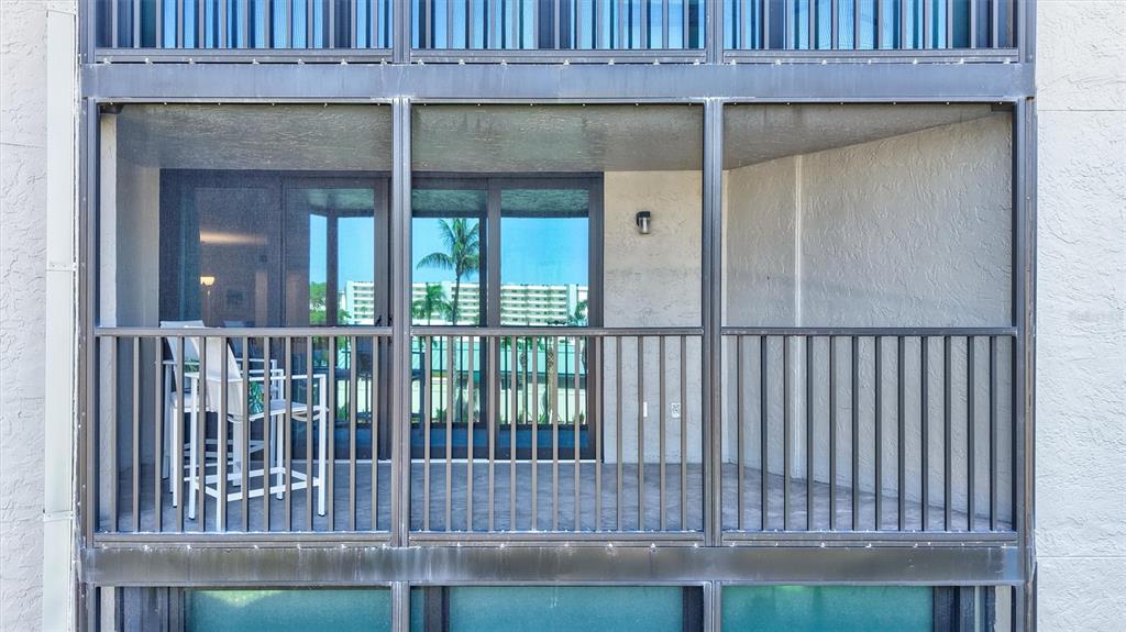 5880 Midnight Pass Road, Unit 306 Sarasota, FL 34242 - Photo 44 of 71 a view of a wooden door and a yard