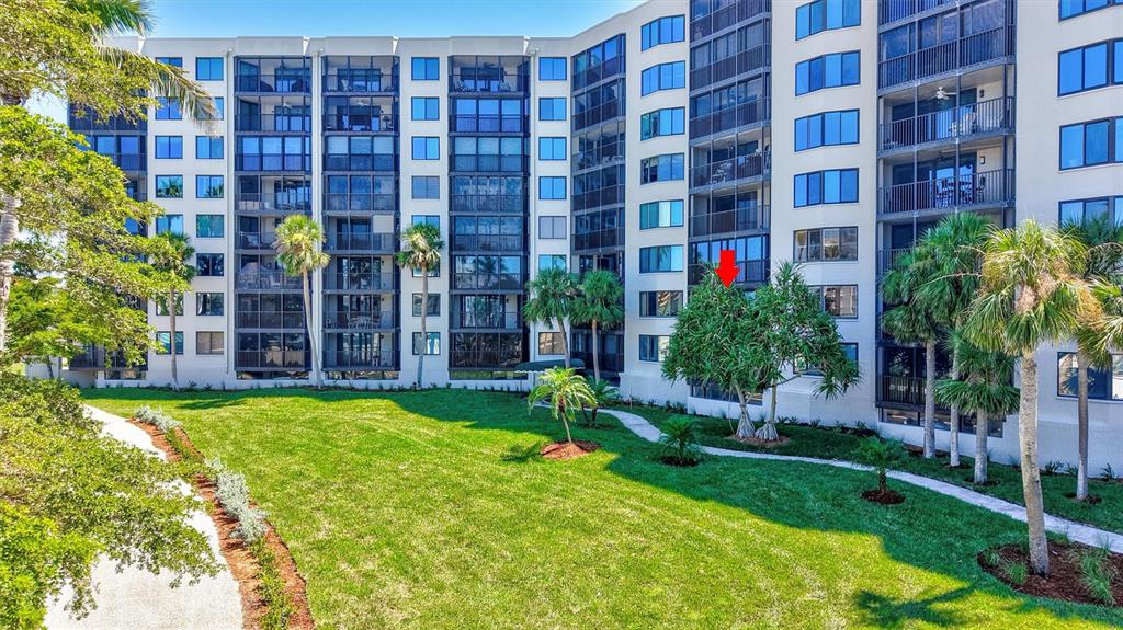 5880 Midnight Pass Road, Unit 306 Sarasota, FL 34242 - Photo 46 of 71 a view of a building with garden