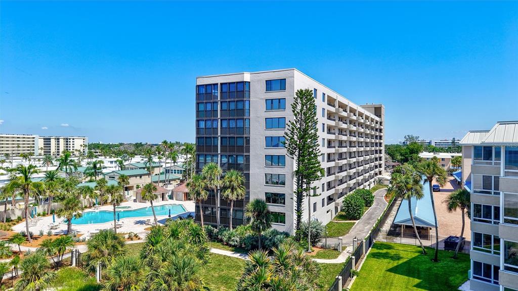 5880 Midnight Pass Road, Unit 306 Sarasota, FL 34242 - Photo 47 of 71 a front view of a house with a yard