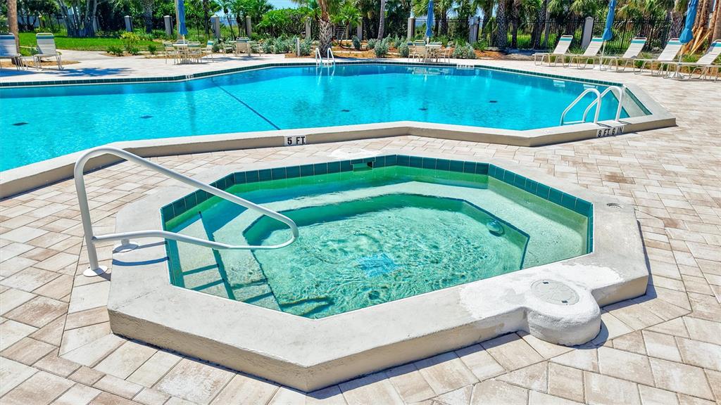 5880 Midnight Pass Road, Unit 306 Sarasota, FL 34242 - Photo 52 of 71 a view of a swimming pool with a outdoor seating
