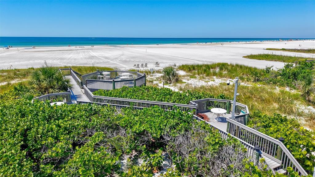 5880 Midnight Pass Road, Unit 306 Sarasota, FL 34242 - Photo 57 of 71 a view of a swimming pool and an outdoor seating