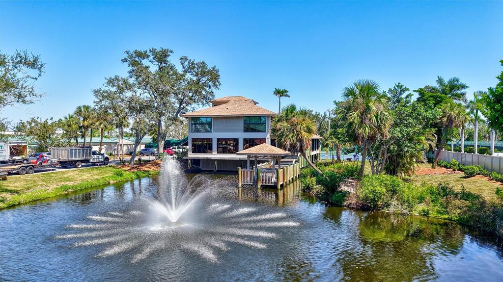 5880 Midnight Pass Road, Unit 306 Sarasota, FL 34242 - Photo 66 of 71 a view of a swimming pool with lawn chairs and plants