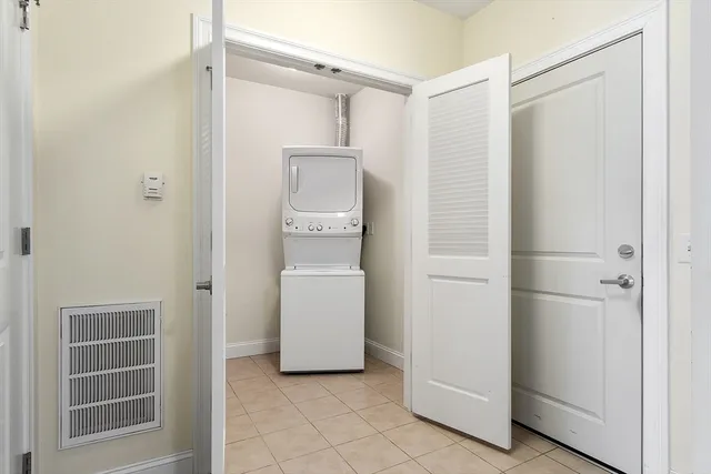 a utility room with cabinets washer and dryer