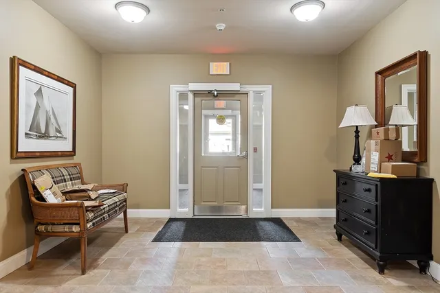 a living room with furniture a lamp and a window