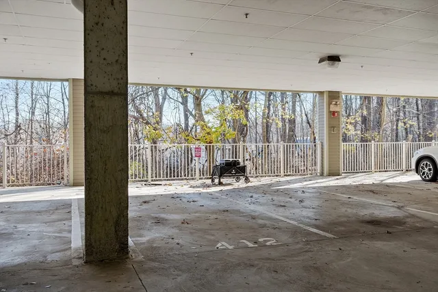 a front view of a building with glass windows and garage