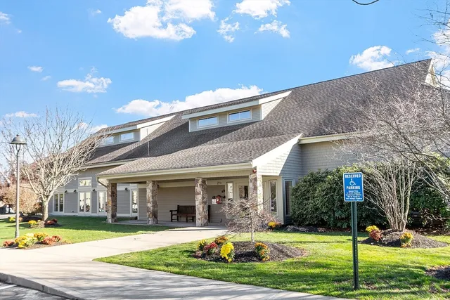 a view of a dining room with lots of wooden furniture and a chandelier