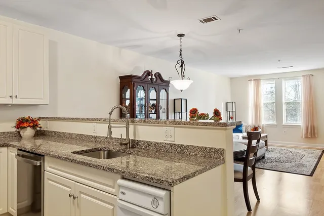a kitchen with a sink a counter and cabinets