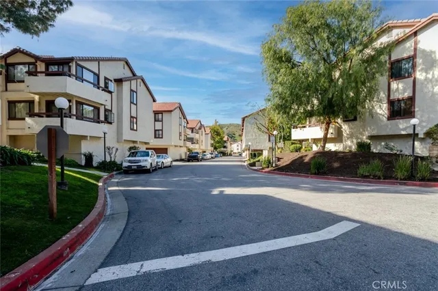 a city street lined with buildings and trees